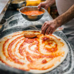chef making pizza.